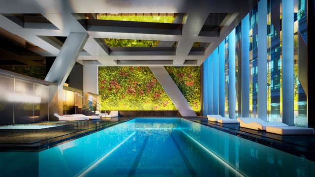 a vertical garden designed by patrick blanc overlooks a 65-foot lap pool