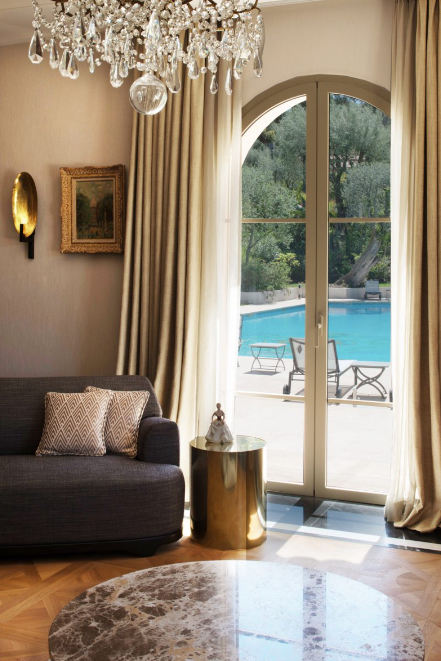 Davide Rizzo Architects Villa Joya view of the pool, here we see the couch and a side table with a Buda on table.  davide rizzo architects Davide Rizzo Architects: Best Interior Design Projects Dabide Rizzo Villa Joya P19 08 davide rizzo cannes cap ferrat design Riviera chic france living room 0x1200 c default