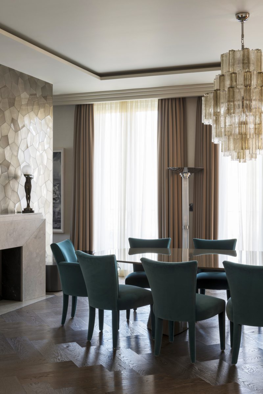 Davide Rizzo Architects Villa in Berlin-Grunewald living room, here we have a dinning table with blue tables around it and a fire place with a big celling chandelier.  davide rizzo architects Davide Rizzo Architects: Best Interior Design Projects Davide Rizzo villa berlin P09 08 davide rizzo interior design private villa grunewald dining murano chandelier donghia salon chair 0x1200 c default