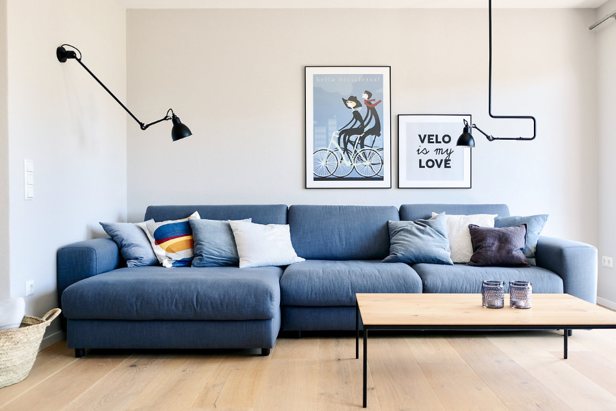 Casa Coulon- Interior Design Inspirations  for Your Home Neubau Reihenhaus Oberland living room with a blue sofa a light wooded center table and some wall lamps.  casa coulon Casa Coulon- Interior Design Inspirations for Your Home BB Casa coulon fullsizeoutput 895 2
