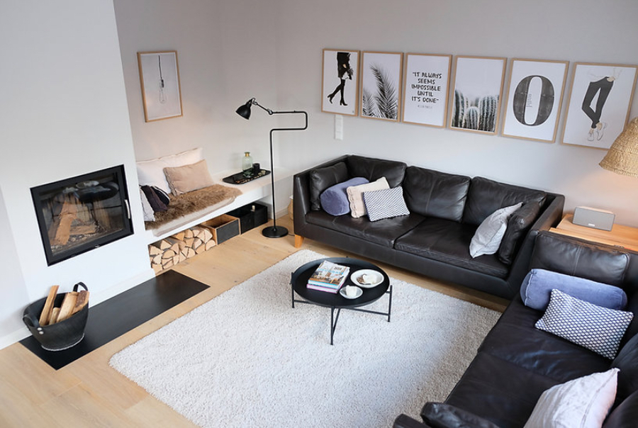 Casa Coulon- Interior Design Inspirations for Your Home Planung DHH Oberland living room, with two clack sofas, a white rug with a coffee table on top; a reading corner with a floor lamp and a fire place.  casa coulon Casa Coulon- Interior Design Inspirations for Your Home BB casa coulonEG Wohnzimmer1 186d