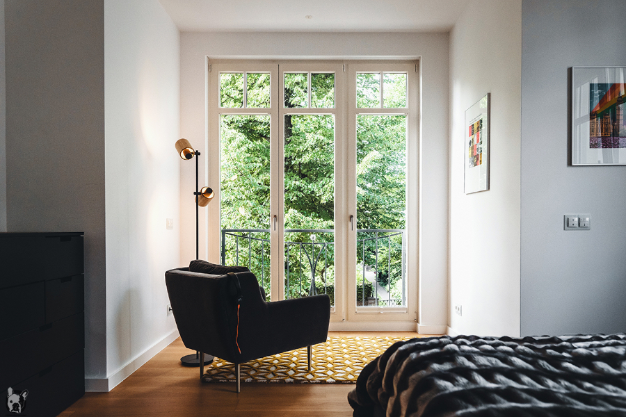 Otto Von Berlin-Interior Design Apartment Berlin Grunewald bedroom with a black arm chair facing the balcony.  otto von berlin Otto Von Berlin-Interior Design Otto Von Berlin apartment