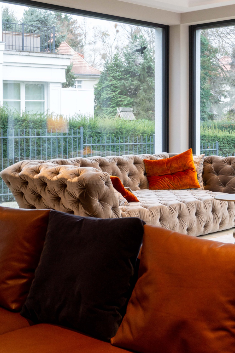 Dopo Domani, STADTVILLA beige sofa with orange pillows.  dopo domani 10 Stunning Dopo Domani Interiors To Inspire You 20181130 dopo domani H s6 012 scaled 1
