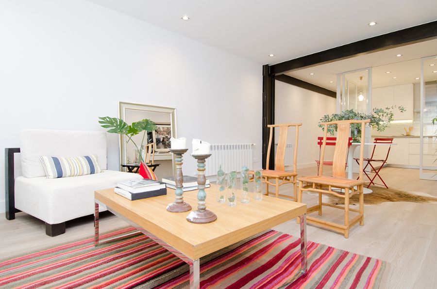 wooden amrchairs, rectangular wooden center table, white armchair, decorative elements, colorful rug estudio marcos mela Estudio Marcos Mela Playful Designs Estudio Marcos Mela Playful Designs1 3 1