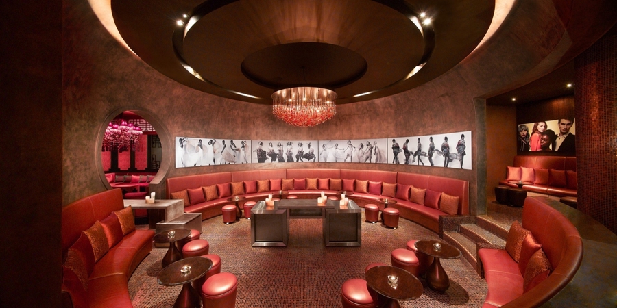 Dark red open living room with bespoke leather upholstery and custom center tables. hba HBA – The Best Interior Design Projects in Dubai HBA3
