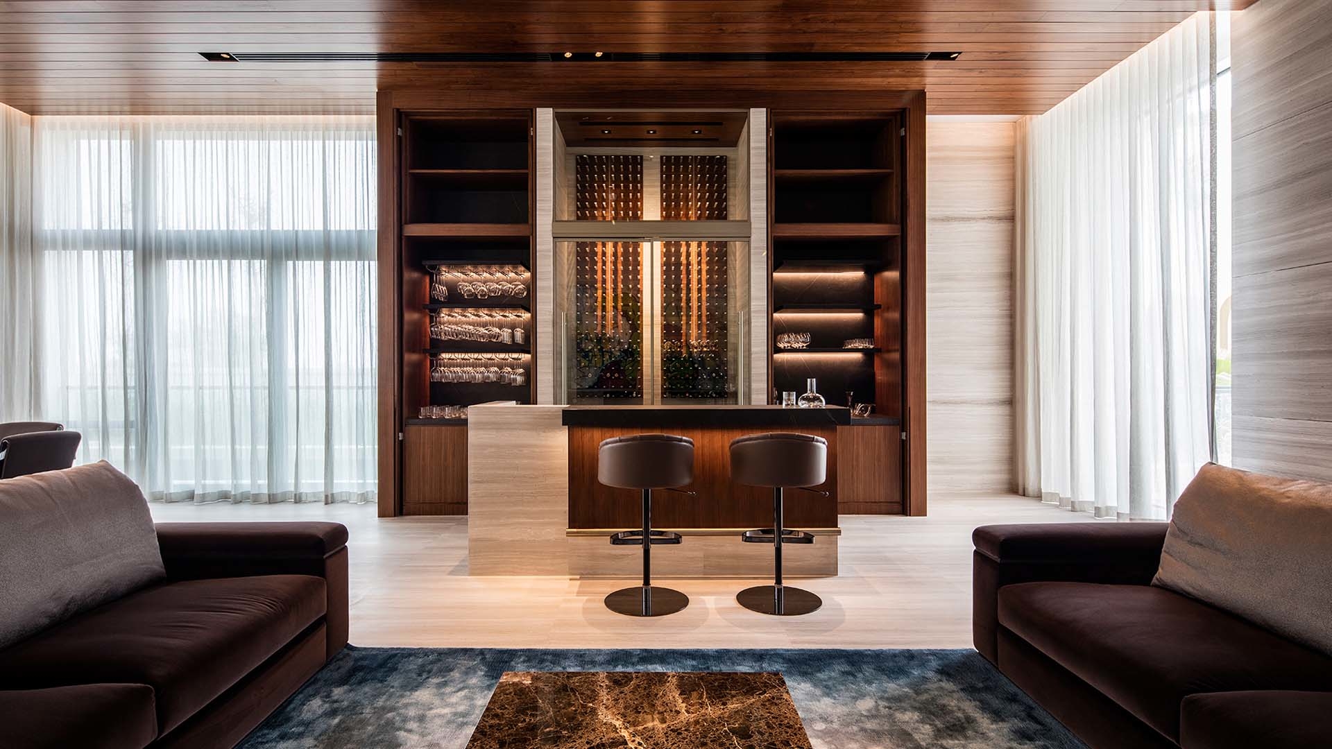 A living room with earth colours, some bespoke sofas and custom bar stools. anarchitect ANARCHITECT – Best Interior Design Inspirations Webp