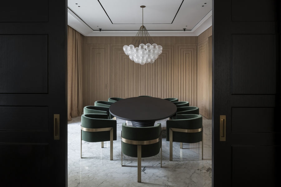 A simple dining room with a glass suspension light combined with a black dining table and some bespoke upholstery.  vshd design VSHD Design – Minimalist Interior Designs Inspirations Webp