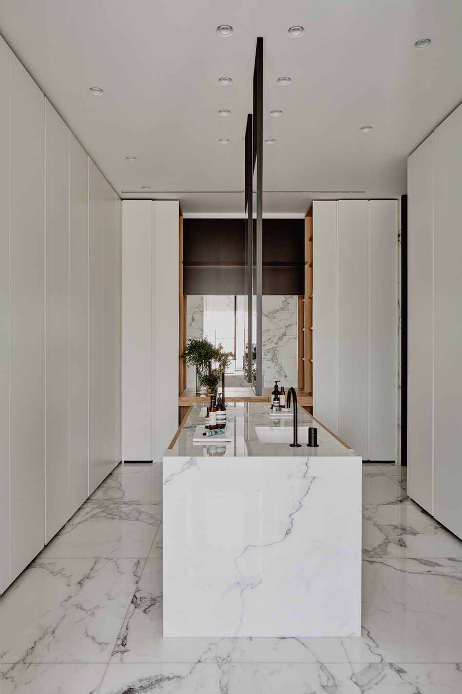 A modern kitchen with the floor made out of marble, so as the center counter. vshd design VSHD Design – Minimalist Interior Designs Inspirations Webp