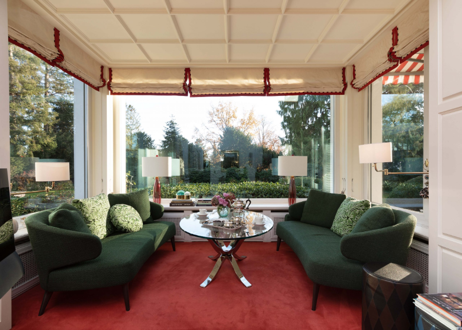 Dopo Domani, REFRESH EINFAMILIENHAUS livign room with 2 green sofas on top of a red carpet, as well as a glass center table  dopo domani 10 Stunning Dopo Domani Interiors To Inspire You dopo domani Private Residence B 025 scaled 1