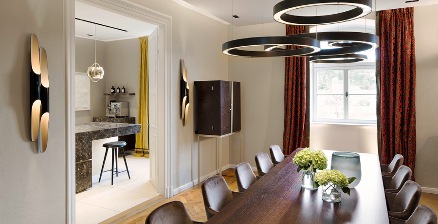 TOWNHOUSE HH modern interior design ideas living room with 2 black wall lamps, some chandeliers over a dining table, we also get a peak into the kitchen.  modern interior design ideas Reimann Architecture: Modern Interior Design Ideas TOWNHO1
