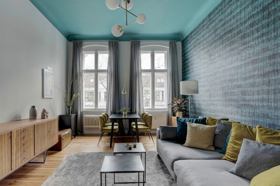 THE INNER HOUSE: living room with yellow dining chairs around the dining table, 2 grey center tabless and a grey sofa the inner house THE INNER HOUSE: Modern Interior Design Ideas Aptm Berlin IV THE INNER HOUSE Living room decor ideas
