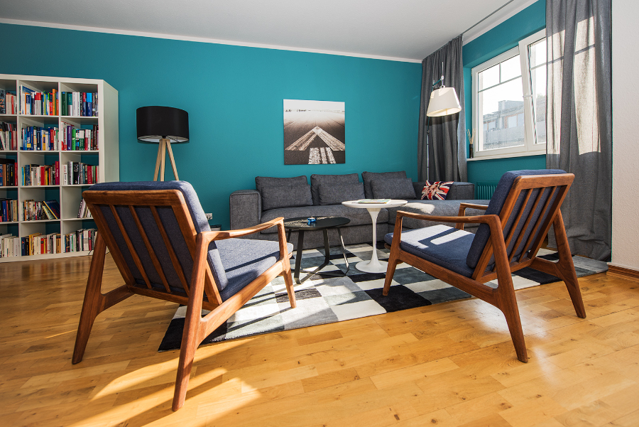 THE INNER HOUSE: living room with a grey sofa and 2 wood armchairs the inner house THE INNER HOUSE: Modern Interior Design Ideas THE INNER HOUSE modern interior design ideas apartment III Berlin 1